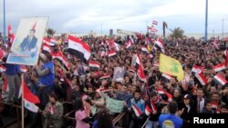 Supporters of Syria's President Bashar al-Assad attend a rally in the northern port city of Tartous, Jan. 12, 2012.