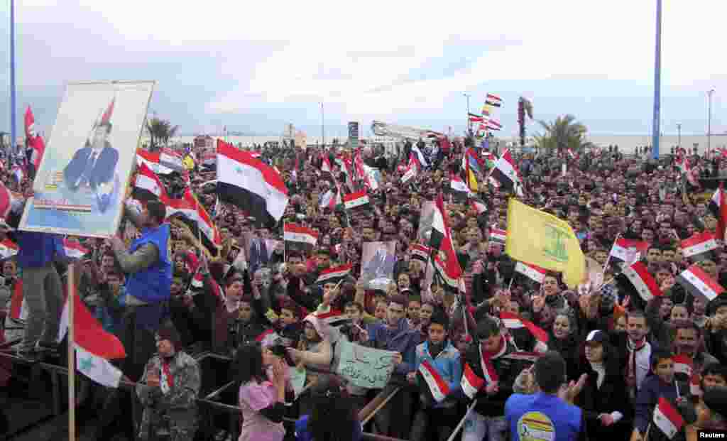 Supporters of Syria's President Bashar al-Assad attend a rally in the northern port city of Tartous, Syria, Jan. 12, 2012.