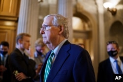 Senate Minority Leader Mitch McConnell, R-Ky., walks past the chamber as the Senate advances to formally begin debate on a roughly $1 trillion infrastructure plan at the Capitol in Washington, July 30, 2021.