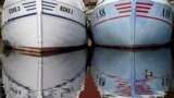 Fishing boats are reflected in the harbor in Eckernfoerde, at the Baltic Sea, Germany. Weather forecasts predict sunny weather in most parts of Germany over the weekend.