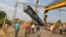 A damaged coach of a passenger train is removed after it derailed near Kuneru village in Vizianagaram district, in the southern state of Andhra Pradesh, India, Jan. 22, 2017. 