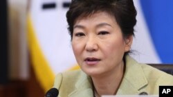 FILE - South Korean President Park Geun-hye speaks during a Cabinet Council meeting at the presidential Blue House in Seoul, South Korea, Dec. 10, 2013.