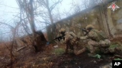 In this photo taken from video released by Russian Defense Ministry Press Service on Dec. 27, 2024, Russian soldiers battle outside Vuhledar, Donbas region, Ukraine. 