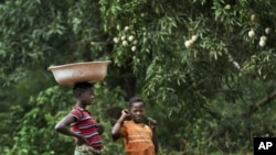 Children watch a convoy of troops from the Central African Republic, Uganda, U.S. Army special forces, and media, drive through Obo, Central African Republic, April 29, 2012.