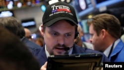 A trader wears a Donald Trump hat while working on the floor of the New York Stock Exchange shortly after the opening bell in New York, March 16, 2017.