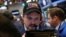 A trader wears a Donald Trump hat while working on the floor of the New York Stock Exchange shortly after the opening bell in New York, March 16, 2017.