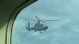 (FILE) A Chinese military helicopter flies close to a Philippine Bureau of Fisheries and Aquatic (BFAR) aircraft above Scarborough shoal on Tuesday, Feb. 18, 2025.