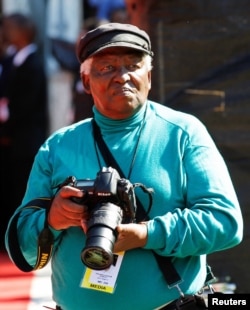 FILE - Veteran photojournalist Peter Magubane looks on during the funeral of Albertina Sisulu, a leading light of the former anti-apartheid movement and widow of an early mentor of Nelson Mandela, in Johannesburg, South Africa June 11, 2011.