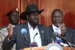 South Sudan President Salva Kiir gives a press conference jointly with his former vice-president and political rival Riek Machar, right, after they met at the State House in Juba, Feb. 20, 2020.