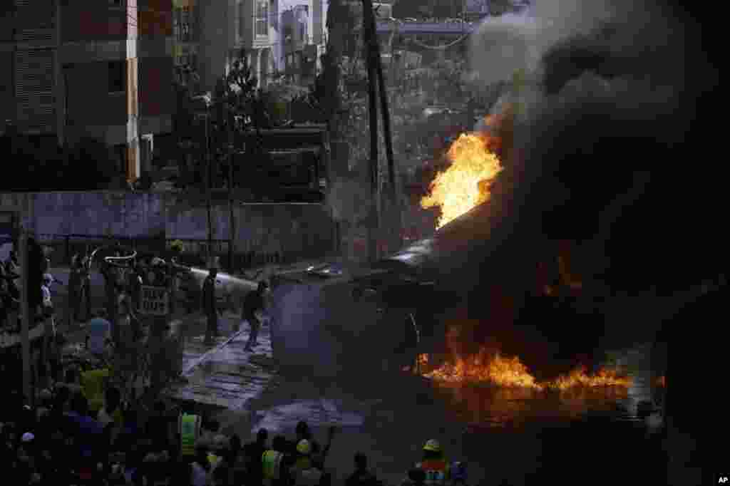Firefighters try to contain a tanker that overturned and caused a large fuel fire outside the Oando petrol station in Lagos, Nigeria, on May 1, 2020. 