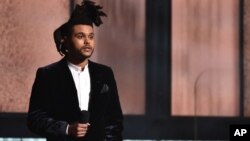 The Weeknd introduces a performance by Pharrell Williams at the 57th annual Grammy Awards, Feb. 8, 2015, in Los Angeles. 