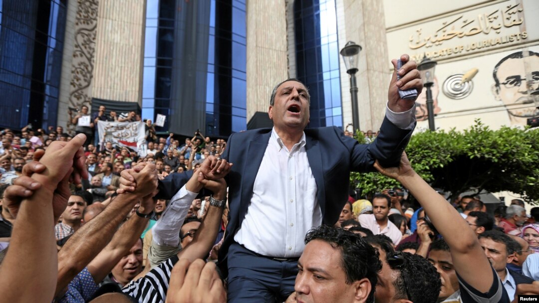 FILE - Journalists carry Yehia Qalash, head of the Egyptian press syndicate, during a protest against restrictions on the press and to demand the release of detained journalists, in front of the Press Syndicate in Cairo, Egypt May 4, 2016.
