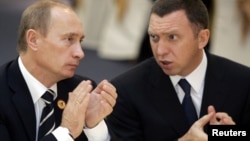 Foto de 2006 del presidente ruso Vladimir Putin junto al magnate Oleg Deripaska, propietario de Rusal, una de las empresas sancionadas por Estados Unidos.