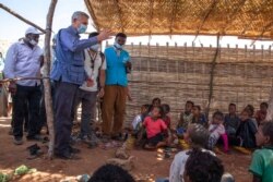 FILE - Filippo Grandi, U.N. high commissioner for refugees, visits Umm Rakouba refugee camp, which is sheltering people who fled the conflict in Ethiopia's Tigray region, in Qadarif, Sudan, Nov. 28, 2020.