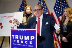 FILE - Former Mayor of New York Rudy Giuliani, a lawyer for President Donald Trump, speaks during a news conference at the Republican National Committee headquarters, November 19, 2020, in Washington.