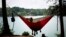 People sitting in a hammock in Laurel Park, Gainesville, Georgia, June 8, 2015.