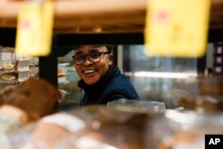 FILE—Ella Anthony smiles during an interview in the supermarket where she works, in Rome, March 26, 2024.