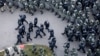 FILE - Belarusian riot police block the road to stop demonstrators during an opposition rally to protest the official presidential election results in Minsk, Belarus, Nov. 15, 2020.