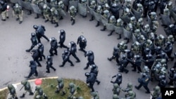 FILE - Belarusian riot police block the road to stop demonstrators during an opposition rally to protest the official presidential election results in Minsk, Belarus, Nov. 15, 2020.