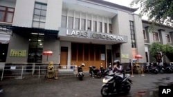 A motorcyclist passes by Kerobokan prison where American citizen Christian Beasley was detained for hashish drug offense, in Bali, Indonesia, Dec. 11, 2017.