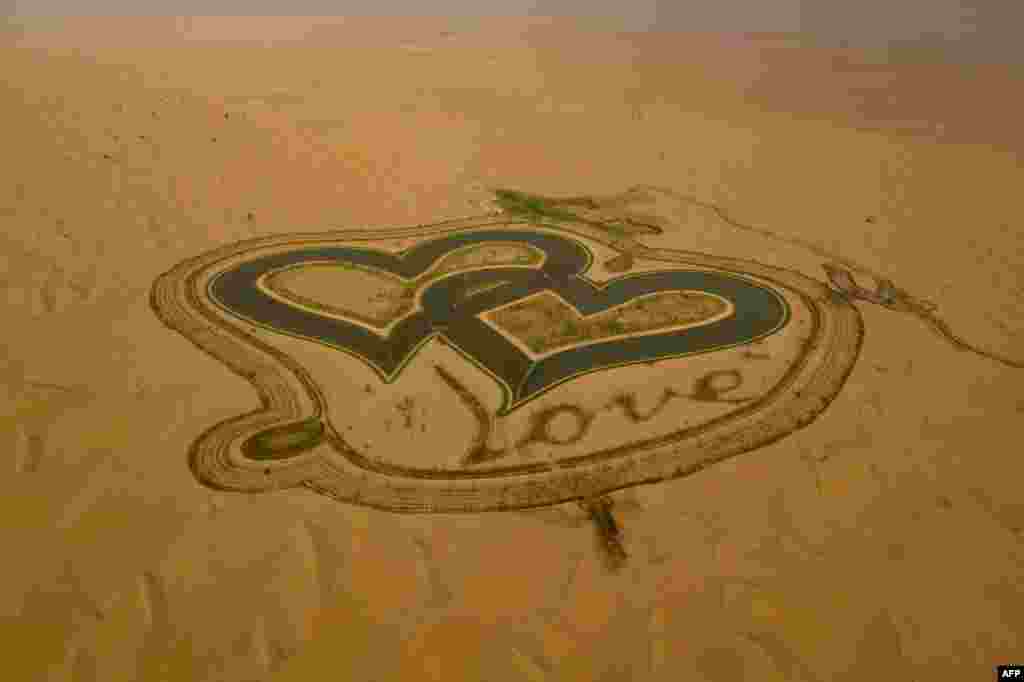 A picture taken with a drone shows the new man-made &quot;Love lake&quot; at al-Qudra desert in the Gulf emirate of Dubai.