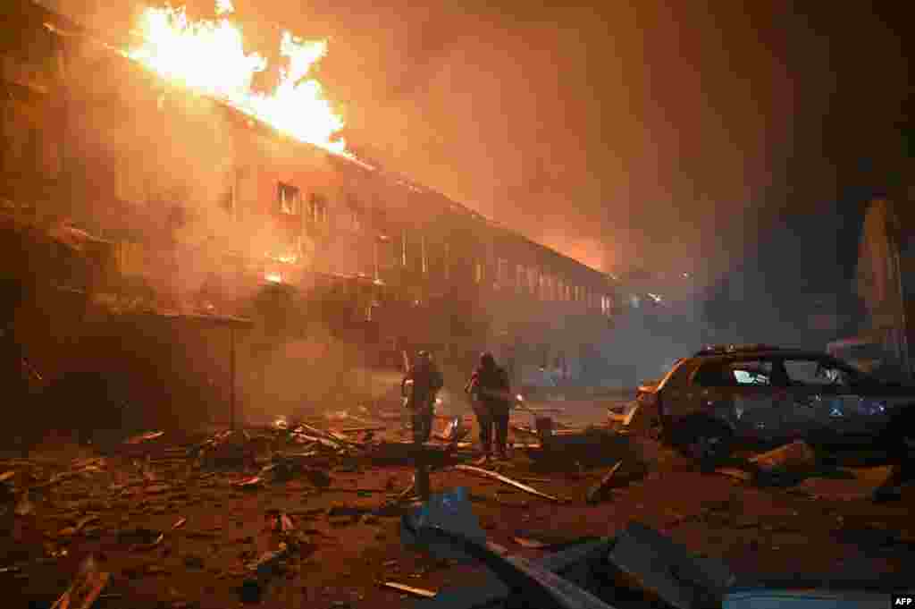 Rescuers of the State Emergency Service work to extinguish a fire in a building after a drone strike in Kharkiv amid the Russian invasion in Ukraine.