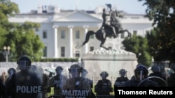 Washington, D.C., National Guard military police officers stand guard as demonstrators rally near the White House in Washington, June 1, 2020, against the death in Minneapolis police custody of George Floyd. 