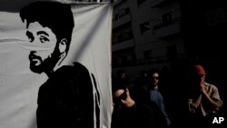 FILE - Families and supporters of Israeli hostages held by Hamas hold photos of their loved ones at a protest calling for their return, outside a meeting between U.S. Secretary of State Antony Blinken and Israeli President Isaac Herzog, in Tel Aviv, Israel, January 9, 2024.