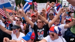With the White House in the background, hundreds of people, many of Cuban descent, protest the Cuban government, July 26, 2021, at Lafayette Park in Washington.