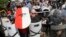 FILE - White nationalist demonstrators use shields as they guard the entrance to Lee Park in Charlottesville, Virginia, Aug. 12, 2017. 