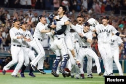 Team Japan celebrates after defeating the USA in the World Baseball Classic at LoanDepot Park on Mar. 21, 2023. (Rhona Wise-USA TODAY Sports)