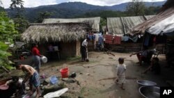 People work near their residence at their Je Yang Internally Displaced Persons (IDP) camp at the headquarters of KIA in Laiza, a border town of China and Myanmar, Kachin State, Myanmar, Tuesday, Oct. 29, 2013. From 1961 until 1994, the KIA fought a grueling and inconclusive war a