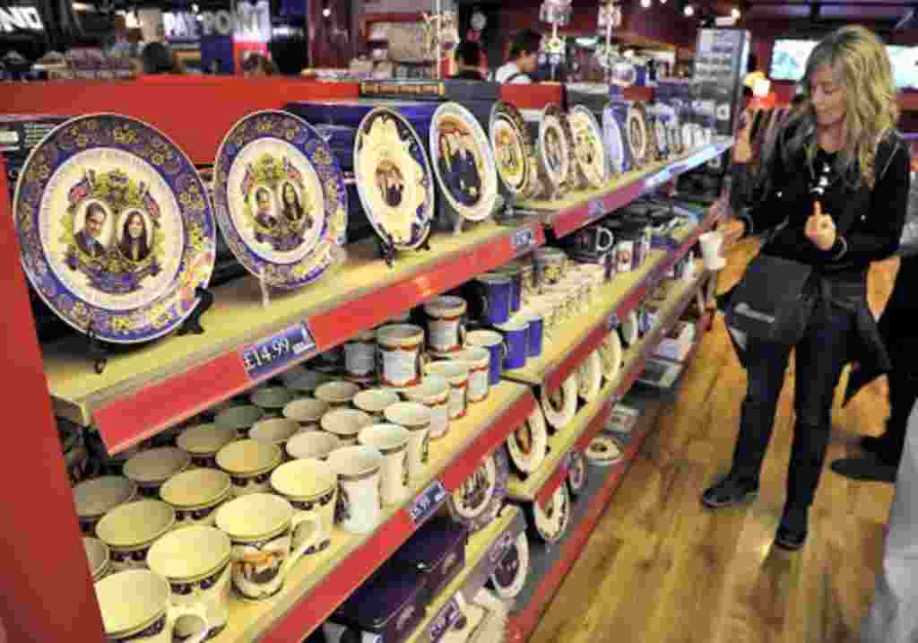 A woman views crockery featuring images of Britain's Prince William and his fiancee Kate Middleton in a souvenir shop in Piccadilly Circus in central London