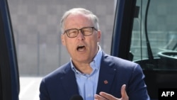 Democratic presidential hopeful Jay Inslee speaks during a tour of the Los Angeles Department of Transportation bus depot in Los Angeles, May 3, 2019. Inslee's campaign centers on climate change and environmental issues.