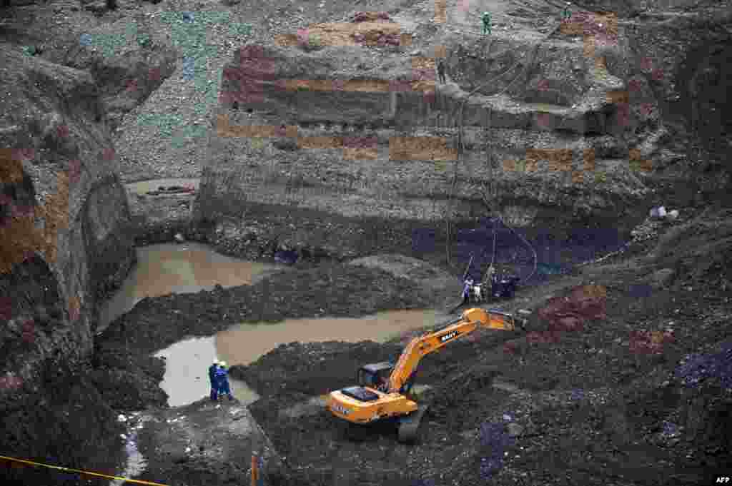 Rescue workers attempt to remove sludge to rescue a group of miners in a gold mine that collapsed in San Antonio, in the rural area of Santander de Quilichao, department of Cauca, Colombia where independent mine workers were excavating the mine without authorization.