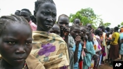 Female child refugees who escaped violence on Sudan's side of the disputed border queue up inside Yida refugee camp, South Sudan, June 30, 2012.