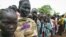 Female child refugees who escaped violence on Sudan's side of the disputed border queue up inside Yida refugee camp, South Sudan, June 30, 2012.