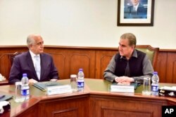 Pakistan's Foreign Minister Shah Mehmood Qureshi, right, meets U.S. envoy Zalmay Khalilzad in Islamabad, Pakistan, Jan. 31, 2020. Khalilzad has met with Pakistan's foreign minister to find a peaceful solution to neighboring Afghanistan's war.