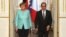 France's President Francois Hollande, right, and German chancellor Angela Merkel arrive to give a press conference, at the Elysee Palace, in Paris, July 6, 2015. 