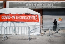 A COVID-19 testing tent is setup on a sidewalk in a predominantly Ultra-Orthodox neighborhood in the Brooklyn borough of New York, March 27, 2020.