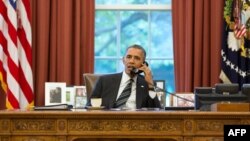 U.S. President Barack Obama speaks with Iranian President Hassan in this official White House photo released Sept. 27, 2013.