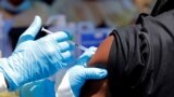 FILE - A health worker injects a man with Ebola vaccine in Goma, Democratic Republic of the Congo, Aug. 5, 2019.