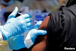 FILE - A health worker injects a man with Ebola vaccine in Goma, Democratic Republic of the Congo, Aug. 5, 2019.