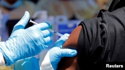 FILE - A health worker injects a man with Ebola vaccine in Goma, Democratic Republic of the Congo, Aug. 5, 2019.