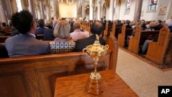 The Ryder Cup sits in the back of the Basilica at Saint Vincent College during a memorial service for golfer Arnold Palmer in Latrobe, Pennsylvania, Oct. 4, 2016.