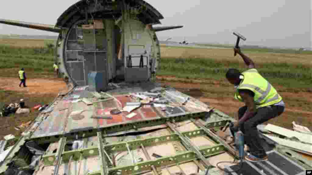 A worker dismantles an abandoned aircraft at Murtala Muhammed International Airport in Lagos, Nigeria.