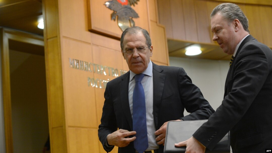 FILE - Russian Foreign Minister Sergei Lavrov, left, speaks with Foreign Ministry spokesman Alexander Lukashevich after holding his traditional start-of-year press conference in Moscow, Jan. 23, 2013.