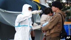 A Congolese girl, displaced by recent fighting in North Kivu, holds a doll at the child friendly space (CFS) within Mugunga III camp for the internally displaced people near Goma, eastern Democratic Republic of Congo.