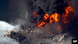 FILE - In an April 21, 2010, photo taken in the Gulf of Mexico, more than 80 kilometers southeast of Venice, La., the Deepwater Horizon oil rig burns. 