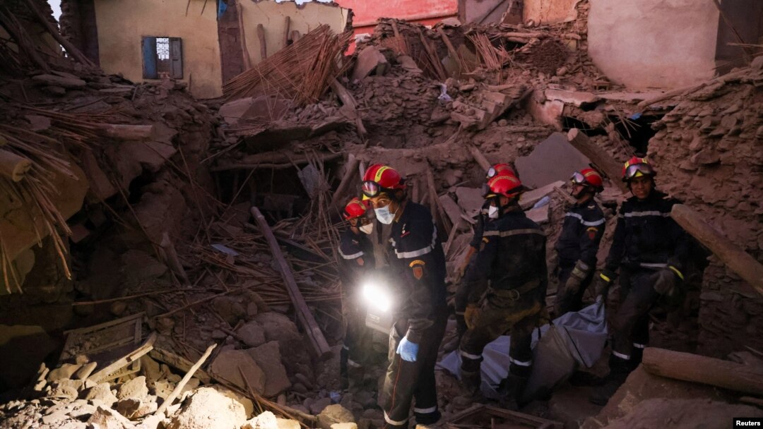 Emergency workers carry bodies following a historic deadly earthquake in Morocco, Sept.10, 2023. 